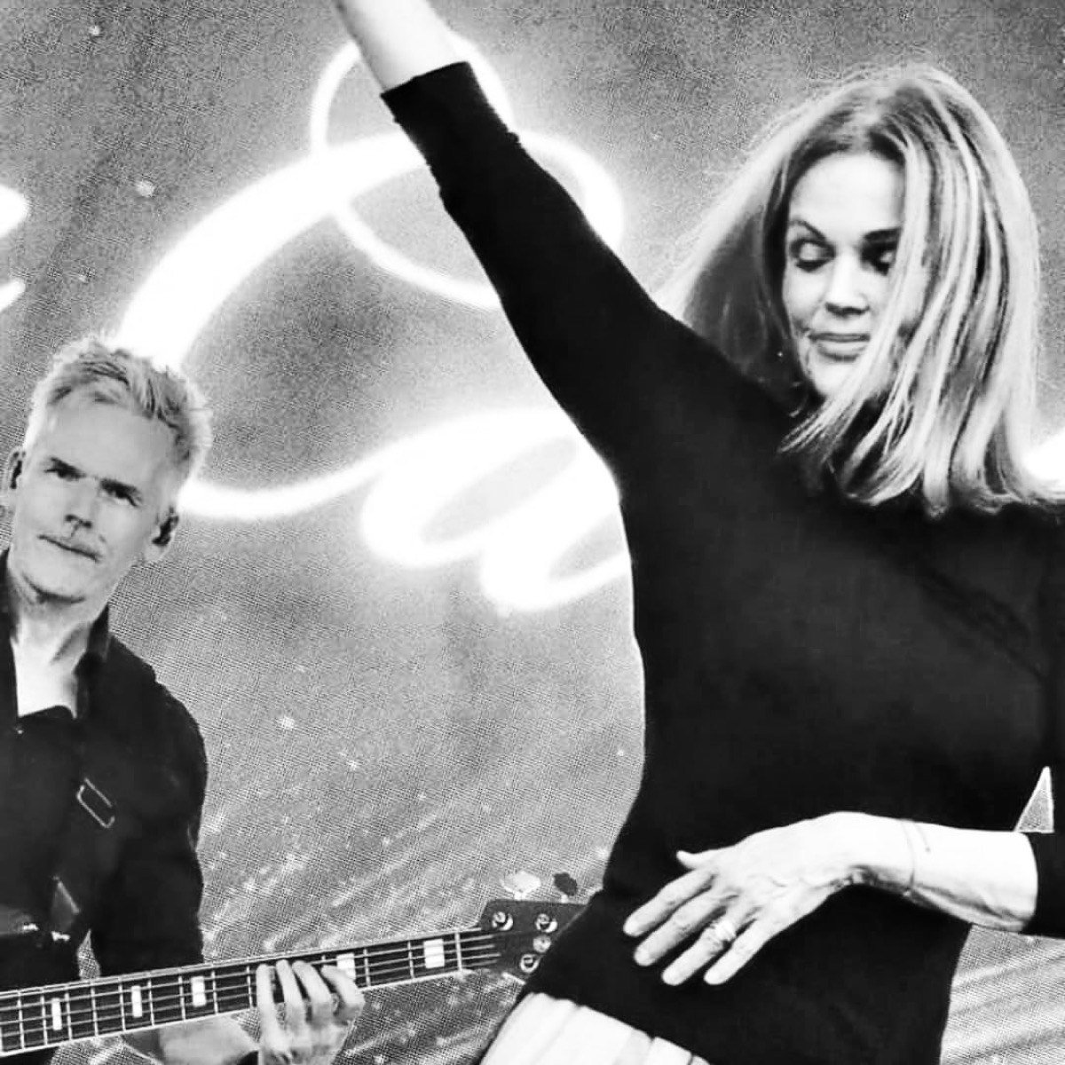 Andy Carr performing on stage with Belinda Carlisle